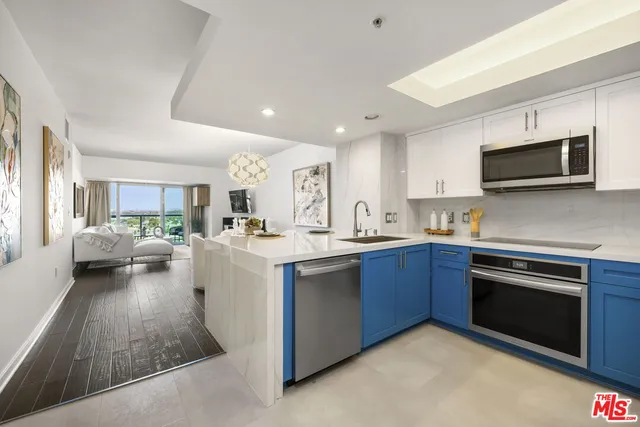 a kitchen with sink a microwave and cabinets