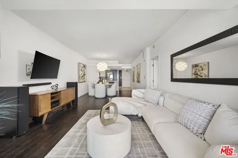 a view of a terrace with couches and lounge chairs