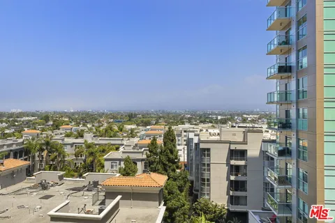 a bedroom with a large bed and a large window