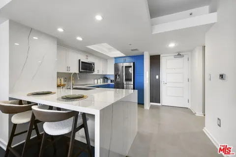 a large kitchen with a table and chairs