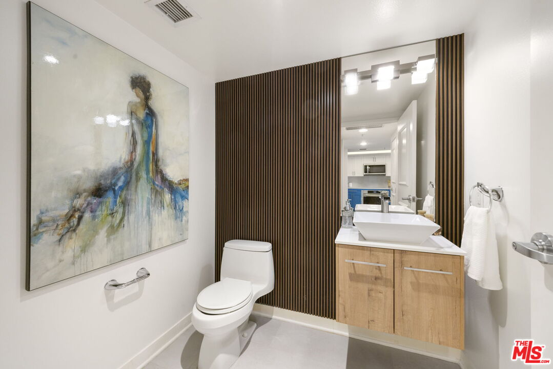 13700 Marina Pointe Drive, Unit 809 Marina del Rey, CA 90292 - Photo 25 of 38 a bathroom with a sink a toilet and shower