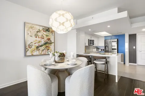 a kitchen with a dining table and chairs