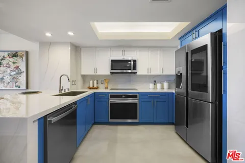 a kitchen with stainless steel appliances granite countertop a refrigerator stove and sink