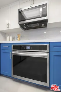 a kitchen with a microwave and cabinets