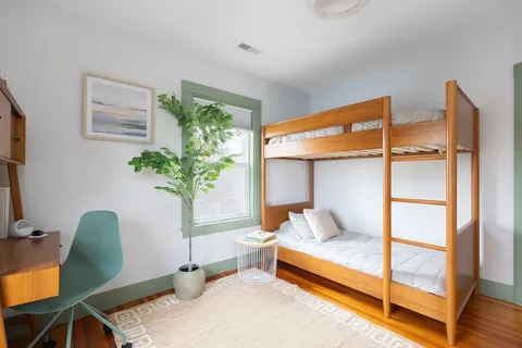 a bedroom with a bed and a potted plant