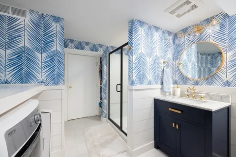 a bathroom with a sink a mirror and a shower