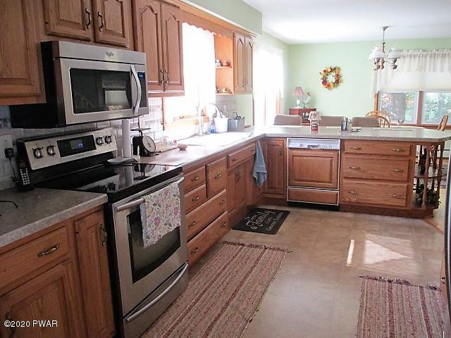 996 Cortez Road Lake Ariel, PA 18436 - Photo 13 of 55 a kitchen with a sink stove and microwave