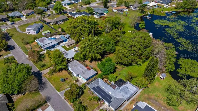 an aerial view of a house with a yard