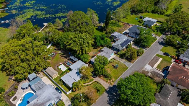 an aerial view of a house with a yard
