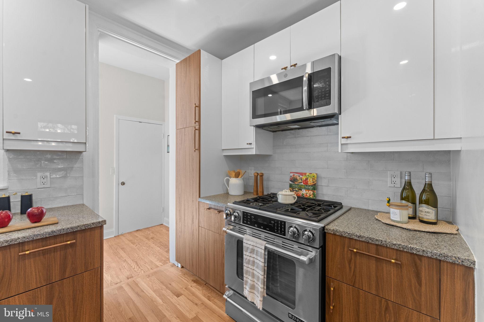 1802 Lamont Street Northwest Washington, DC 20010 - Photo 32 of 118 a kitchen with stainless steel appliances granite countertop a sink and a stove top oven