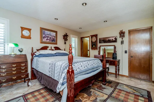 a bedroom with a bed and a dresser in it