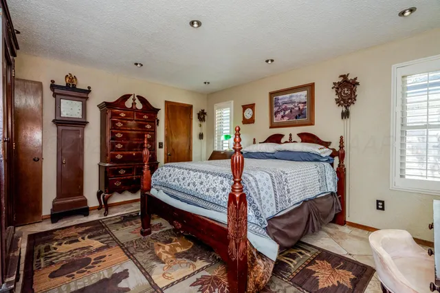 a bedroom with a bed and a dresser in it