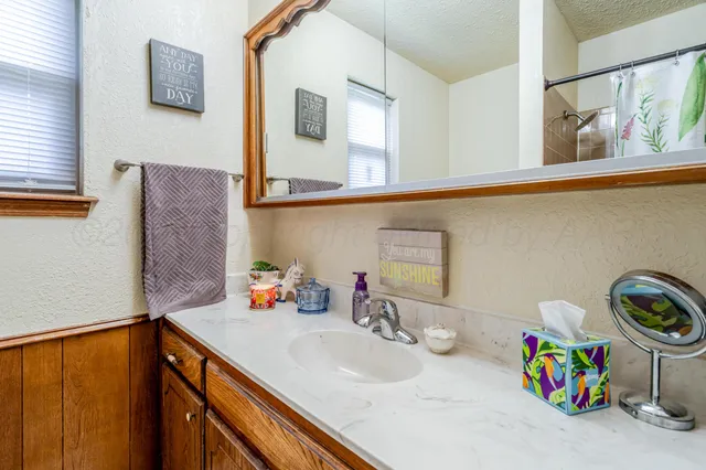 a bathroom with a sink a stove and cabinets