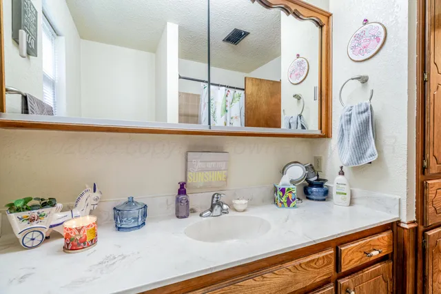 a kitchen with lots of clutter and cabinets
