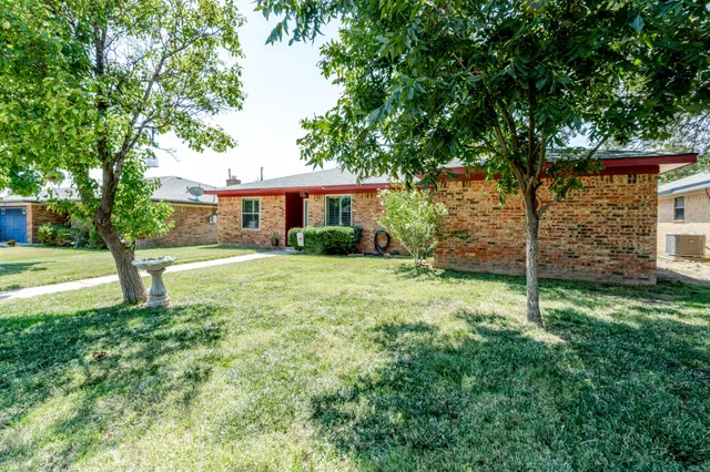 a view of a house with a yard and garage