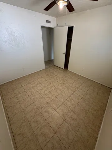 a view of a room with a ceiling fan
