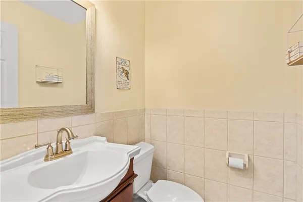 a bathroom with a sink mirror and toilet