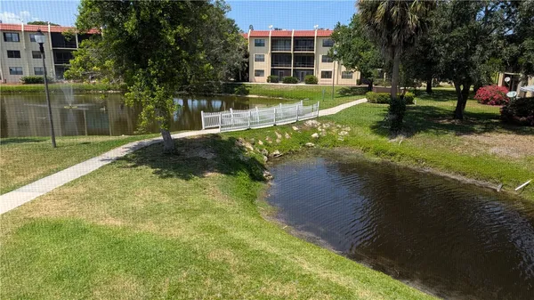 a view of yard with swimming pool and green space