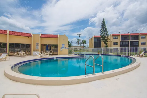 a view of swimming pool with outdoor seating