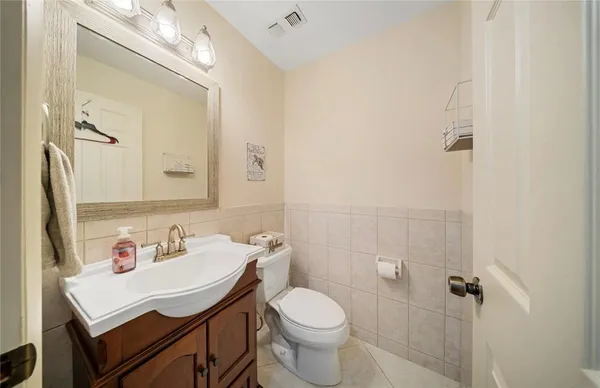 a bathroom with a sink toilet and mirror