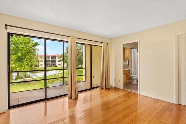 a view of a room with wooden floor and windows