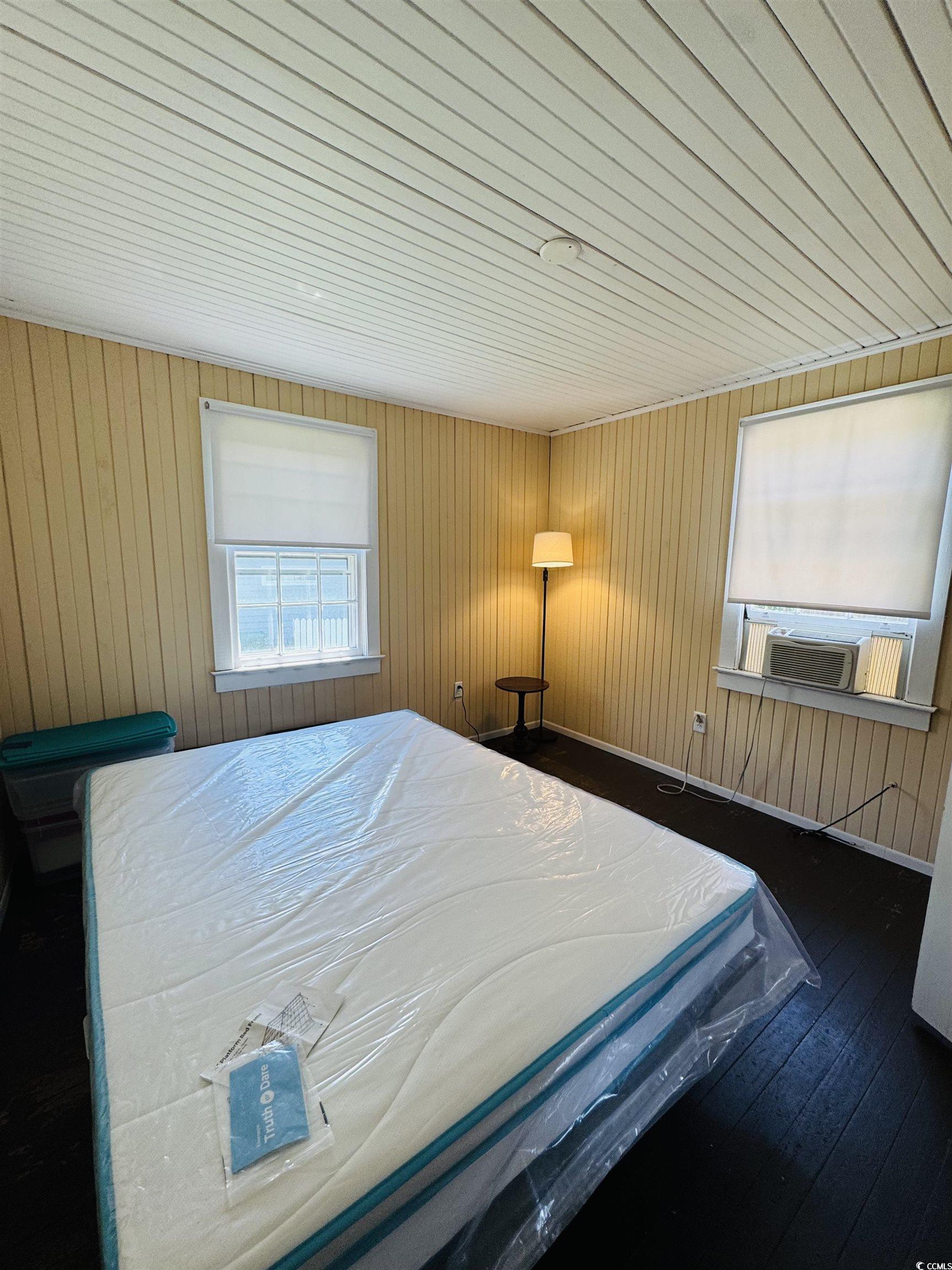 104 East Bay Street Georgetown, SC 29440 - Photo 35 of 40 Apartment Bedroom featuring hardwood / wood-style flooring, wood walls, and wood ceiling