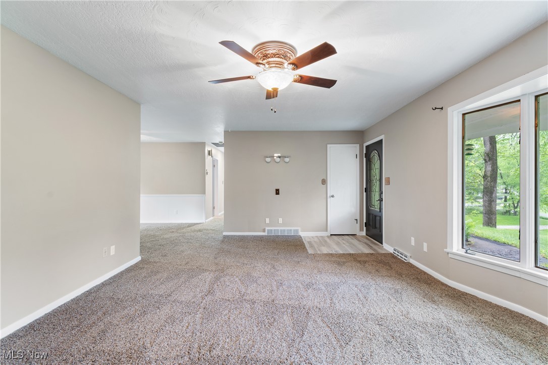 3143 Ethan Allen Road Barberton, OH 44203 - Photo 9 of 37 Empty room featuring light colored carpet and ceiling fan