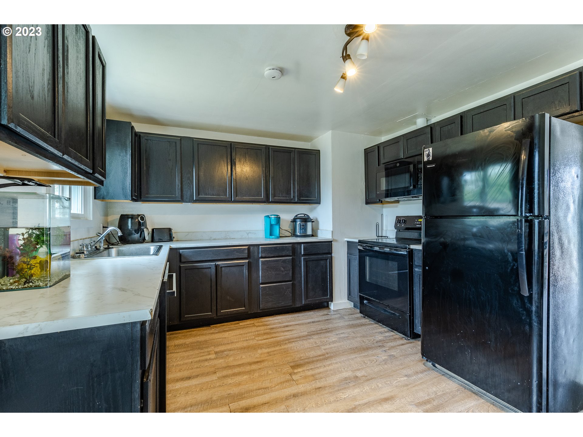 5119 E Street Springfield, OR 97478 - Photo 12 of 28 a kitchen with granite countertop a refrigerator and a sink
