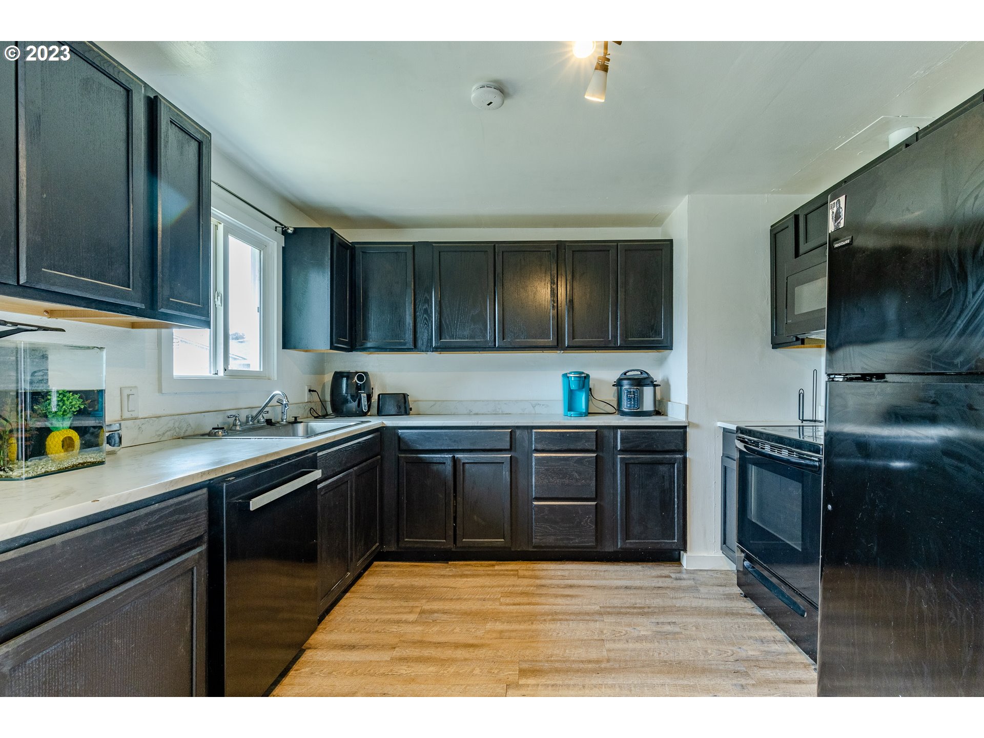 5119 E Street Springfield, OR 97478 - Photo 13 of 28 a kitchen with stainless steel appliances granite countertop a sink and stove top oven