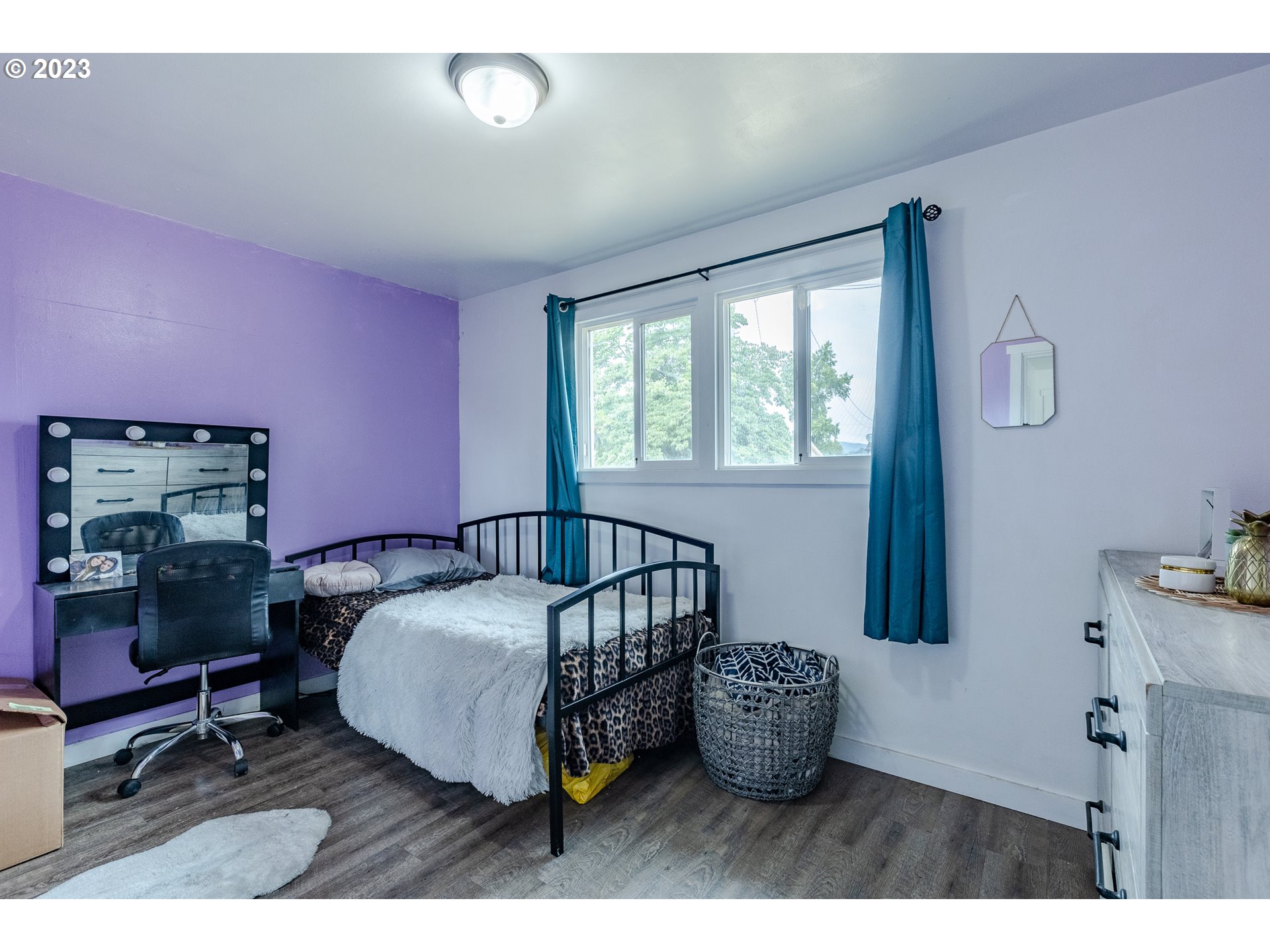 5119 E Street Springfield, OR 97478 - Photo 17 of 28 a bedroom with a bed and wooden floor