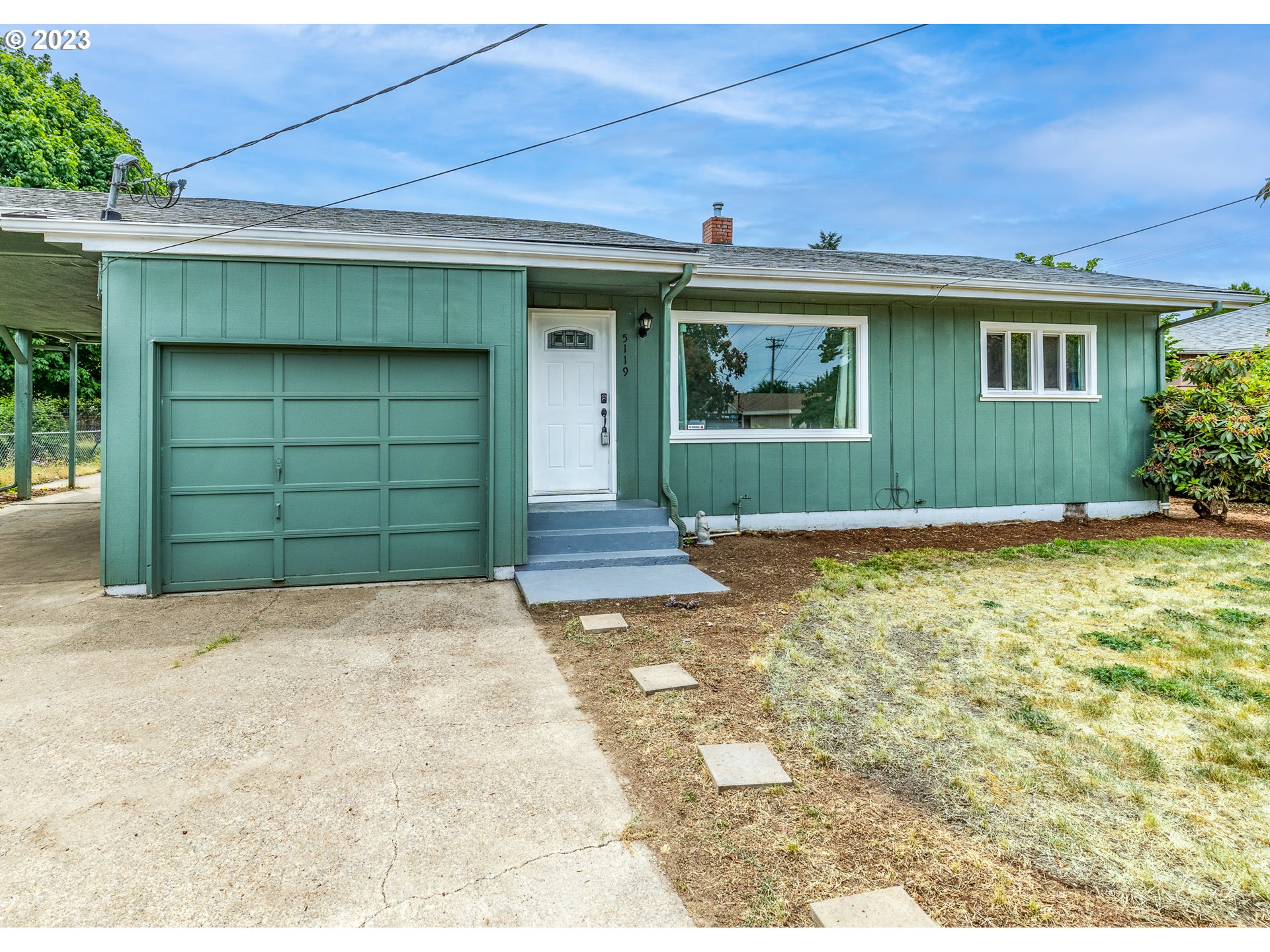 5119 E Street Springfield, OR 97478 - Photo 5 of 28 a front view of a house with a yard and garage