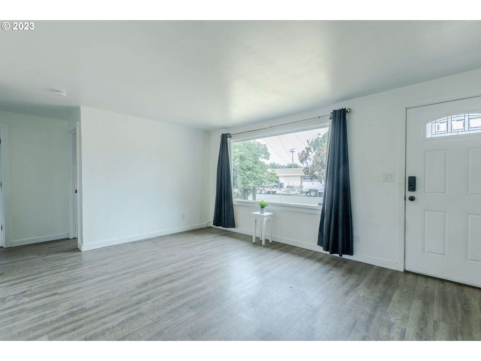 5119 E Street Springfield, OR 97478 - Photo 9 of 28 a view of an empty room with wooden floor and a window