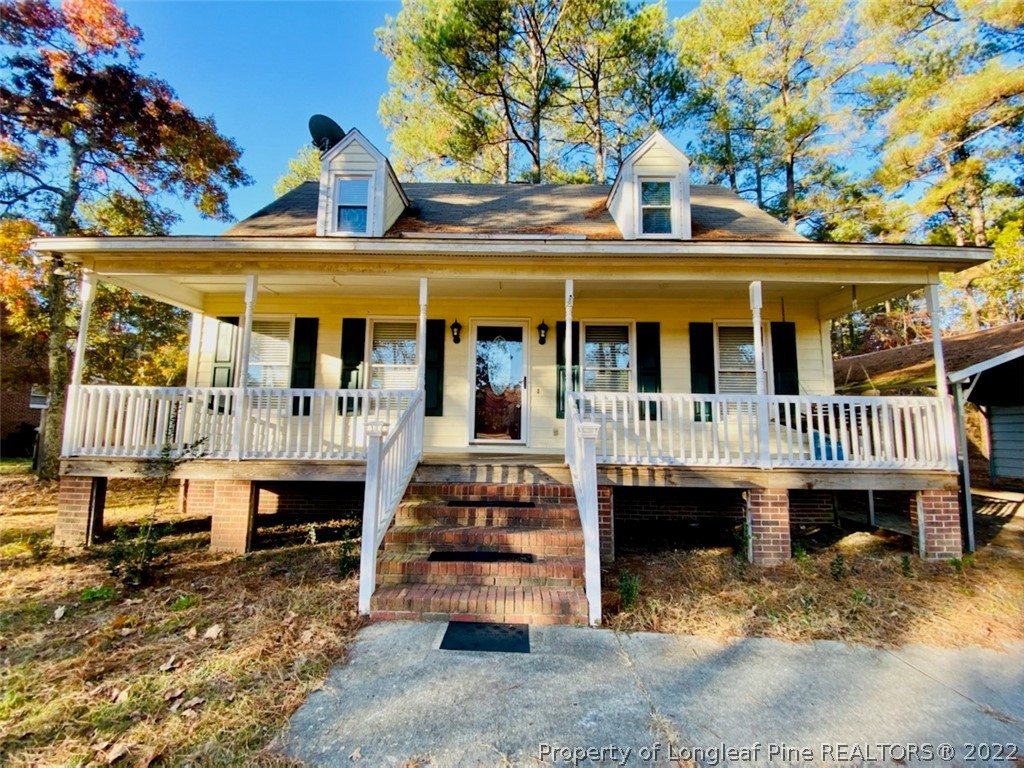 a view of a house with a yard patio and deck