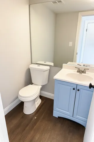 a bathroom with a sink a toilet and mirror