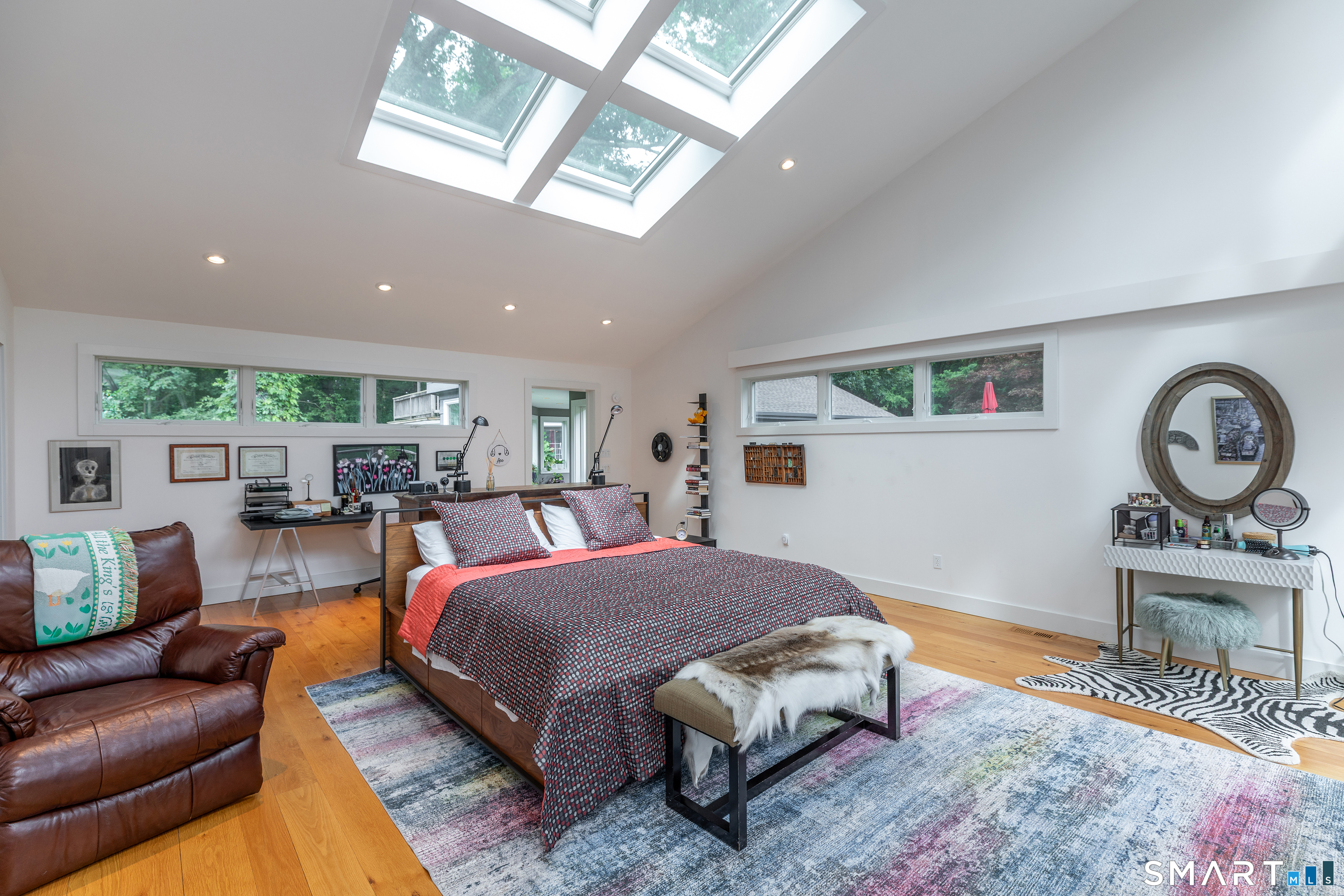 11 Gaffney Road New Milford, CT 06776 - Photo 18 of 39 Light filled primary bedroom with vaulted ceilings, skylights, private deck overlooking your meadow, large dreamy bathroom and walk in closet.