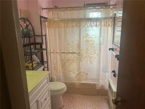 a bathroom with a toilet and a shower