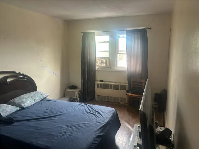 a bedroom with a bed and a mirror