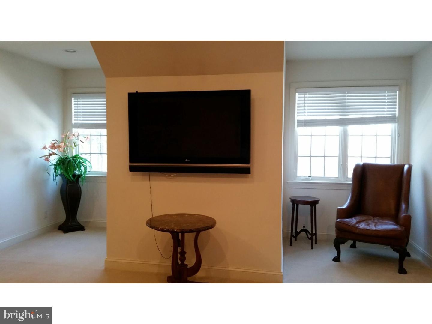 1653 Mt Pleasant Road Villanova, PA 19085 - Photo 8 of 16 a living room with furniture and a flat screen tv