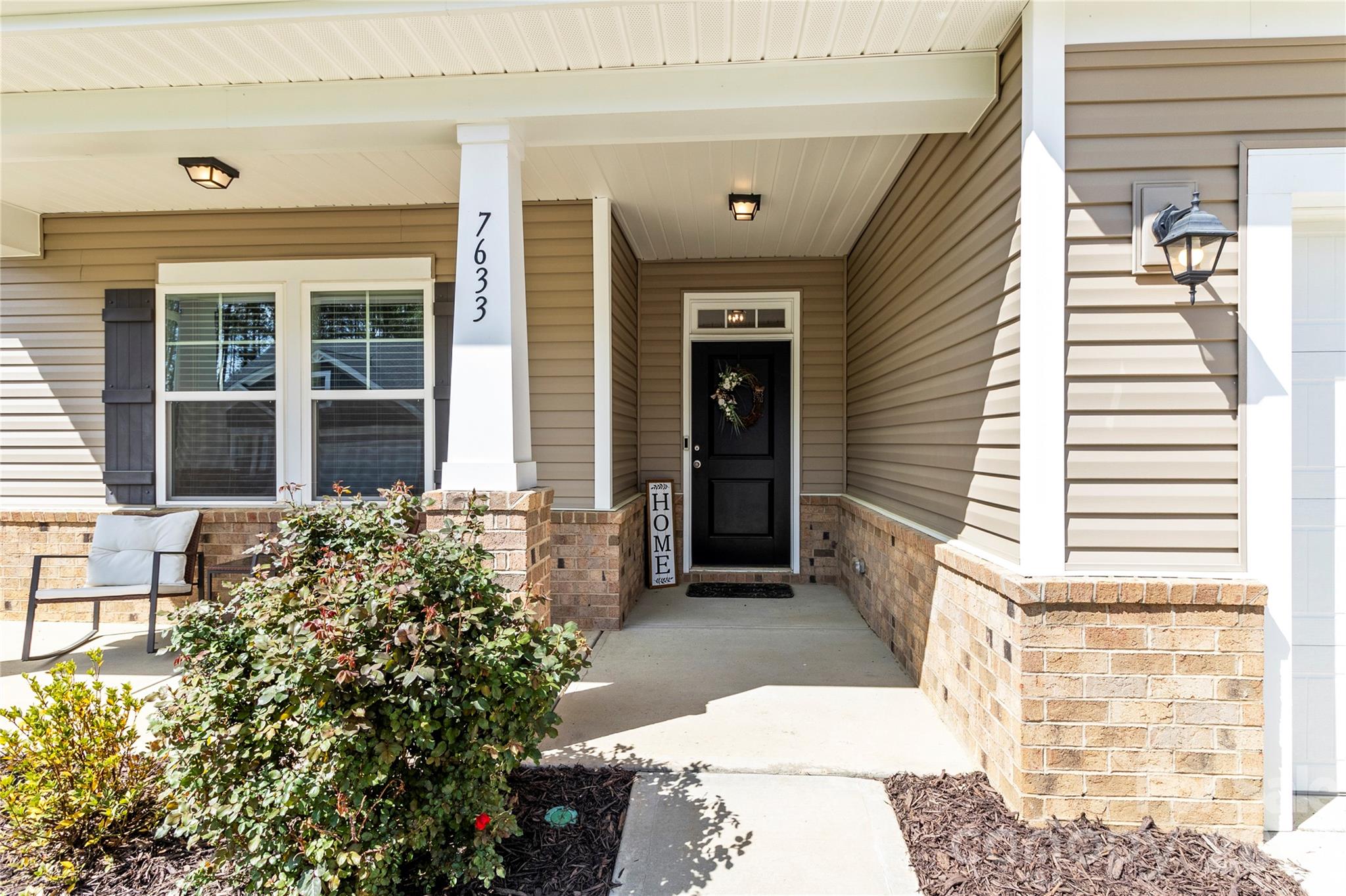 7633 Tanglewood Way Denver, NC 28037 - Photo 2 of 4 a view of a porch with a bench