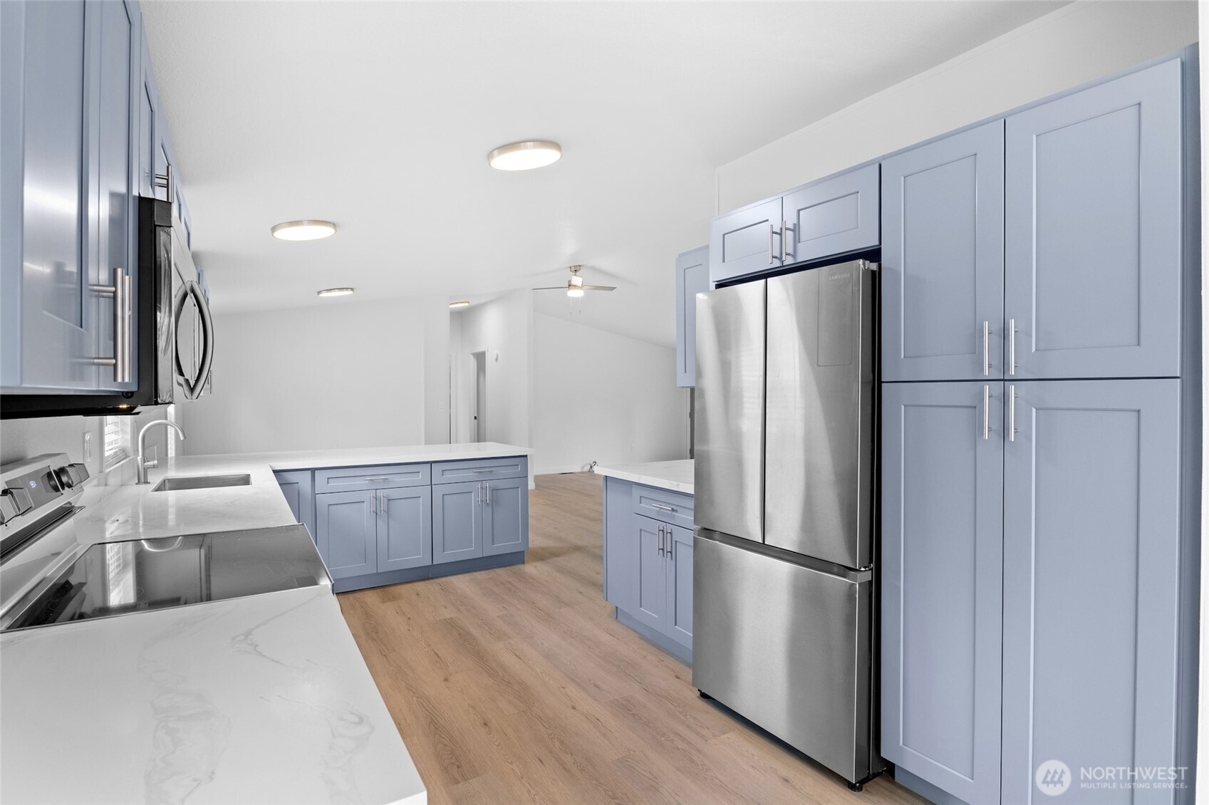 10324 Delphi Road Southwest, Unit 14 Olympia, WA 98512 - Photo 11 of 25 a kitchen with stainless steel appliances a refrigerator and wooden floor