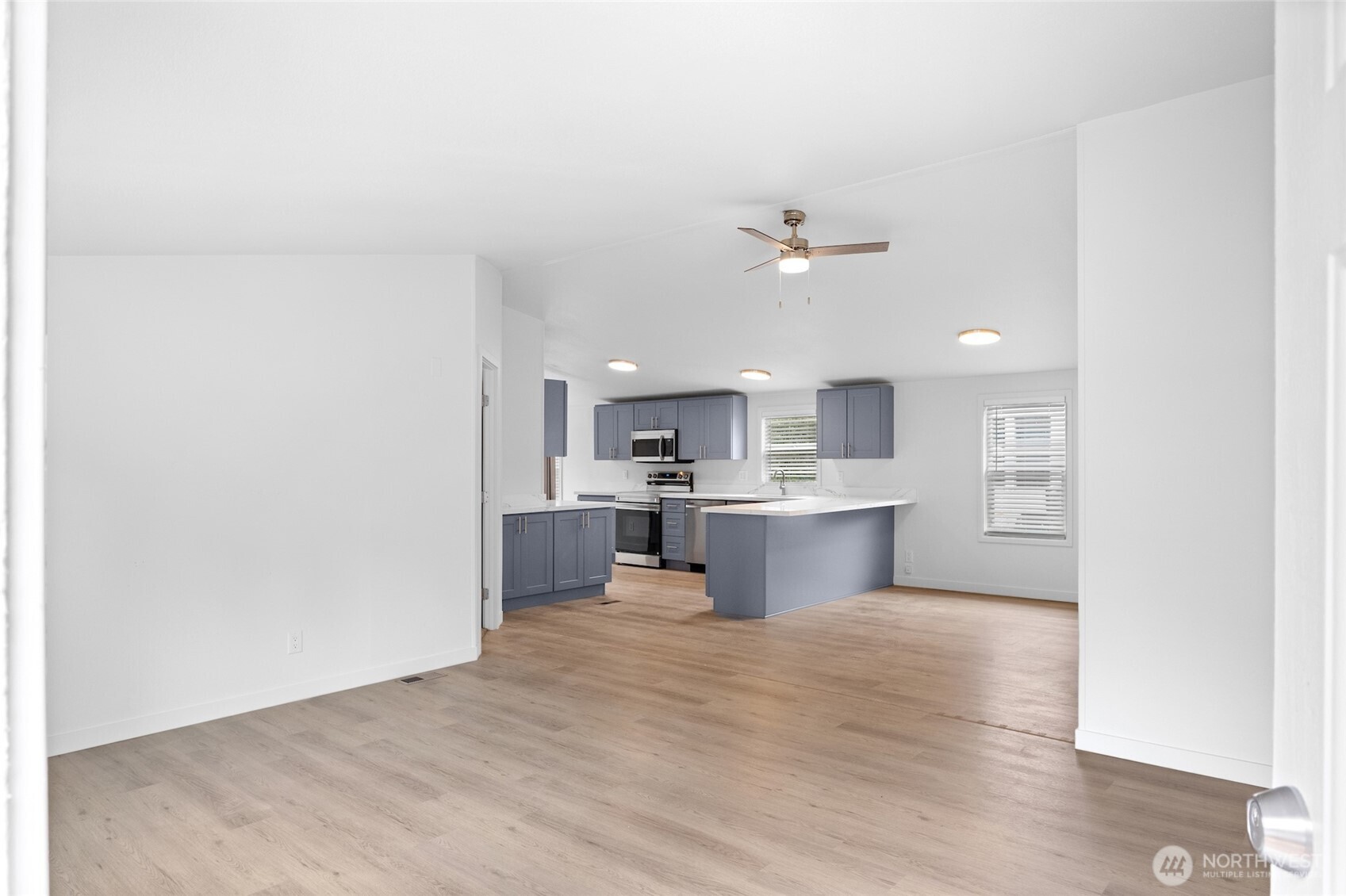 10324 Delphi Road Southwest, Unit 14 Olympia, WA 98512 - Photo 3 of 25 a view of kitchen with stainless steel appliances cabinets and wooden floor