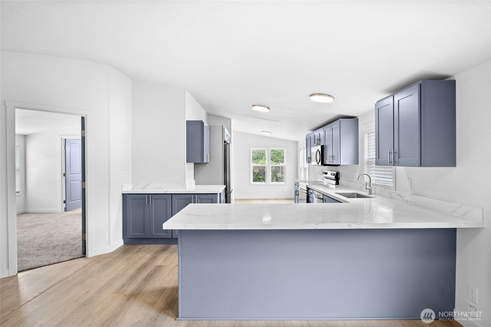 10324 Delphi Road Southwest, Unit 14 Olympia, WA 98512 - Photo 5 of 25 a large white kitchen with a sink and a large mirror