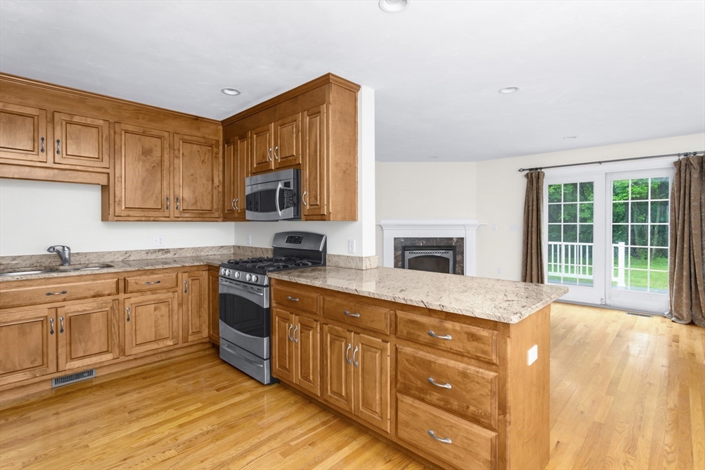 49 Beaver Street, Unit 49 Franklin, MA 02038 - Photo 8 of 46 a kitchen with stainless steel appliances granite countertop a stove and a sink