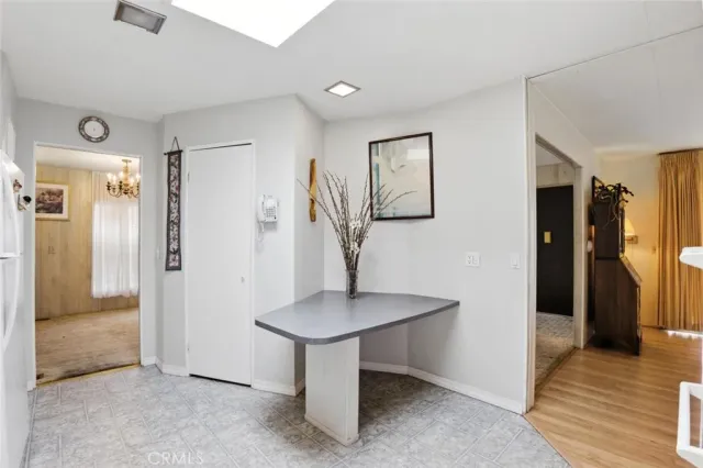 a view of a livingroom with bathroom and a window