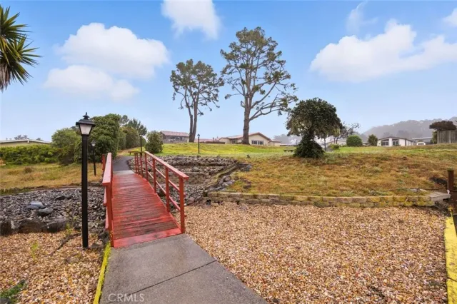 a view of a house with pool and a yard