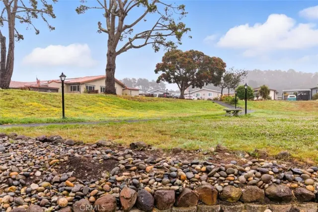 a view of a house with a fountain in a yard