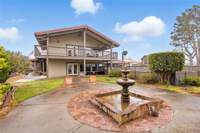 a kitchen with stainless steel appliances granite countertop a refrigerator a stove a sink dishwasher and white cabinets with wooden floor