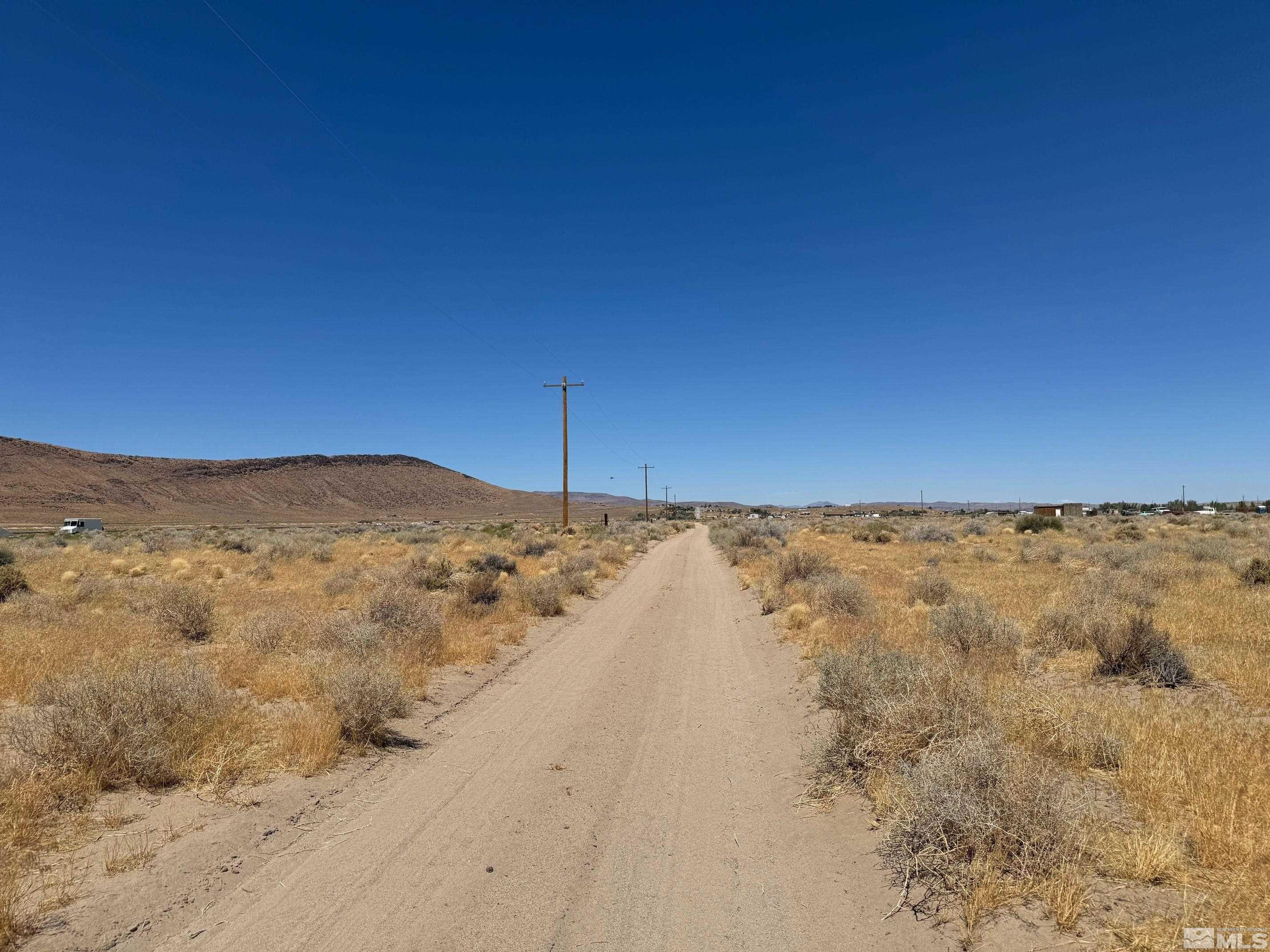 9700 Vía Segundo Silver Springs, NV 89429 - Photo 1 of 7 a view of a yard with a mountain