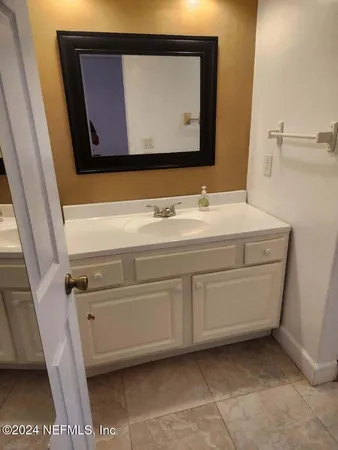 a view of a room with a window and wooden floor