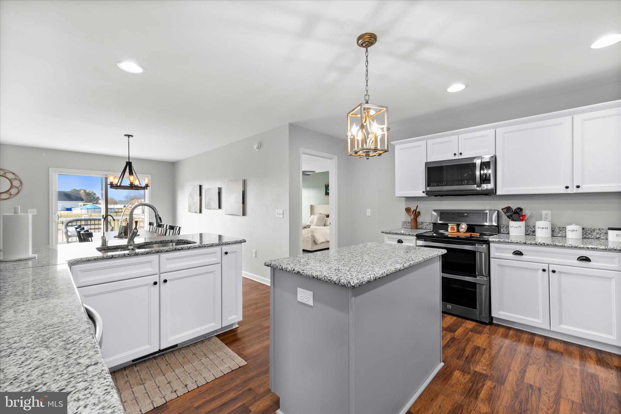 36831 Red Berry Road Delmar, DE 19940 - Photo 18 of 46 a kitchen with stainless steel appliances granite countertop a sink stove and refrigerator